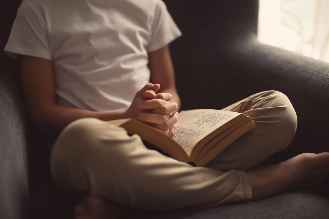 Child Praying with the Bible 